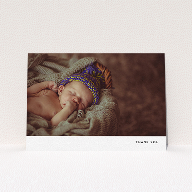 A baby thank you card named "Thankful with Simplicity". It is an A6 card in a landscape orientation. It is a photographic baby thank you card with room for 1 photo. "Thankful with Simplicity" is available as a flat card, with mainly white colouring.