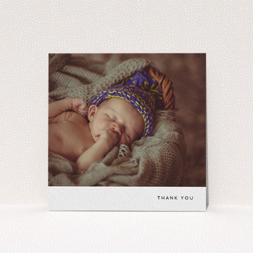 A baby thank you card design named "Thankful with Simplicity". It is a square (148mm x 148mm) card in a square orientation. It is a photographic baby thank you card with room for 1 photo. "Thankful with Simplicity" is available as a flat card, with mainly white colouring.