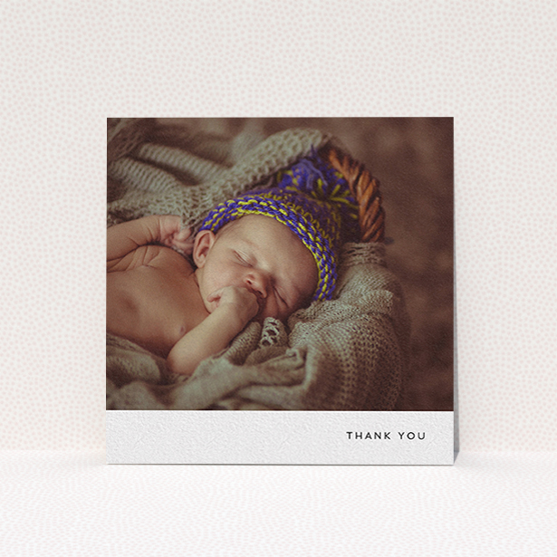 A baby thank you card design named "Thankful with Simplicity". It is a square (148mm x 148mm) card in a square orientation. It is a photographic baby thank you card with room for 1 photo. "Thankful with Simplicity" is available as a flat card, with mainly white colouring.