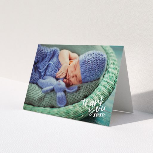 A baby thank you card design called 'Thanks In the Corner'. It is an A5 card in a landscape orientation. It is a photographic baby thank you card with room for 1 photo. 'Thanks In the Corner' is available as a folded card, with mainly white colouring.