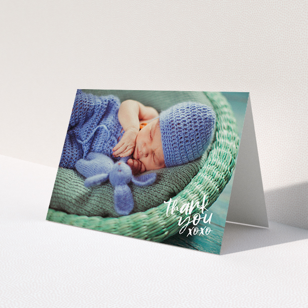 A baby thank you card design called "Thanks In the Corner". It is an A5 card in a landscape orientation. It is a photographic baby thank you card with room for 1 photo. "Thanks In the Corner" is available as a folded card, with mainly white colouring.