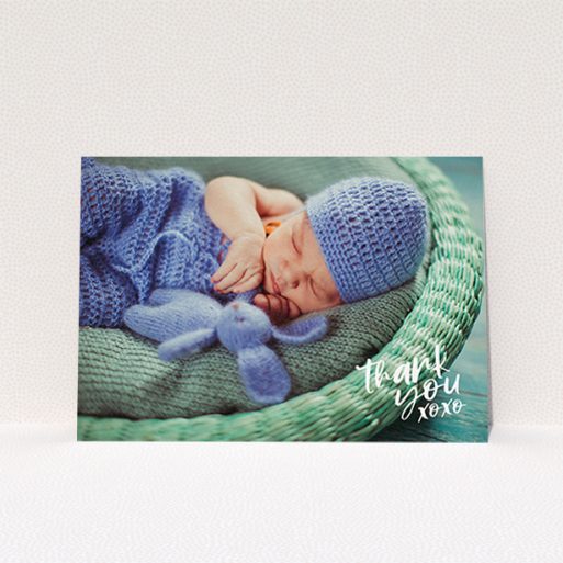 A baby thank you card design titled "Thanks In the Corner". It is an A6 card in a landscape orientation. It is a photographic baby thank you card with room for 1 photo. "Thanks In the Corner" is available as a flat card, with mainly white colouring.