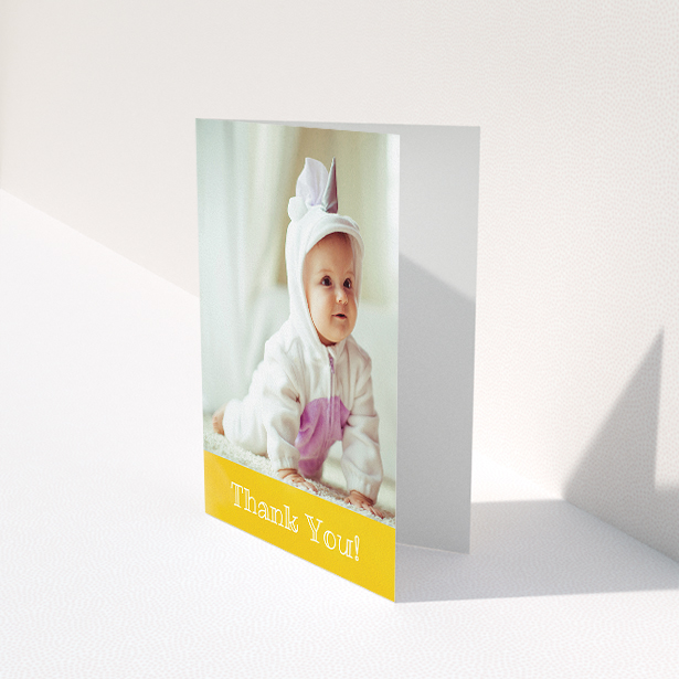 A baby thank you card design called "Thanks In Yellow". It is an A5 card in a portrait orientation. It is a photographic baby thank you card with room for 1 photo. "Thanks In Yellow" is available as a folded card, with tones of yellow and white.