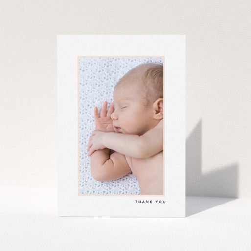 A baby thank you card design named "Thin Pink Frame". It is an A5 card in a portrait orientation. It is a photographic baby thank you card with room for 1 photo. "Thin Pink Frame" is available as a folded card, with tones of white and pink.