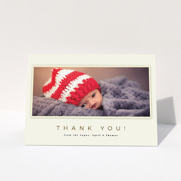 A baby thank you card template titled "Torn Cream Frame". It is an A5 card in a landscape orientation. It is a photographic baby thank you card with room for 1 photo. "Torn Cream Frame" is available as a folded card, with mainly cream colouring.