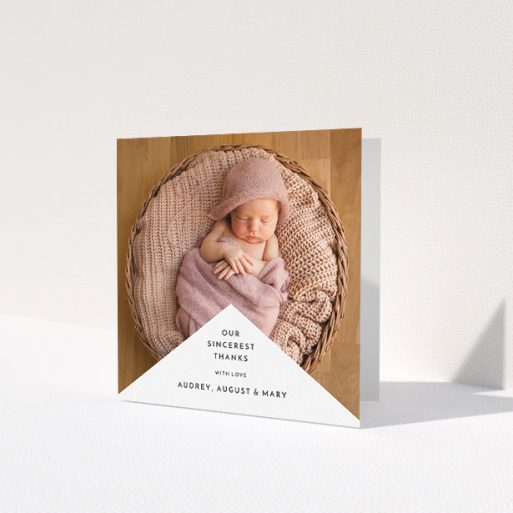 A baby thank you card called 'Wedge Frame'. It is a square (148mm x 148mm) card in a square orientation. It is a photographic baby thank you card with room for 1 photo. 'Wedge Frame' is available as a folded card, with mainly white colouring.