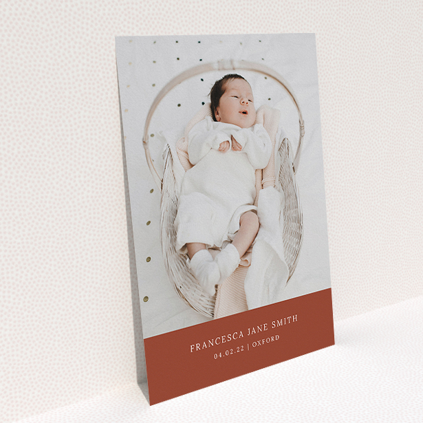 A baptism invitation design named "Autumnal Photo". It is an A5 invite card in a portrait orientation. It is a photographic baptism invitation with room for 1 photo. "Autumnal Photo" is available as a flat invite card, with mainly dark orange colouring.
