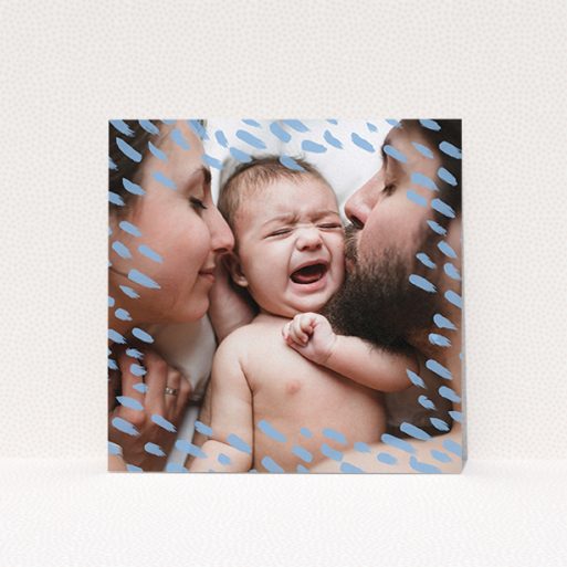 A baptism invitation design named "Blue Dashes". It is a square (148mm x 148mm) invite card in a square orientation. It is a photographic baptism invitation with room for 1 photo. "Blue Dashes" is available as a flat invite card, with mainly blue colouring.