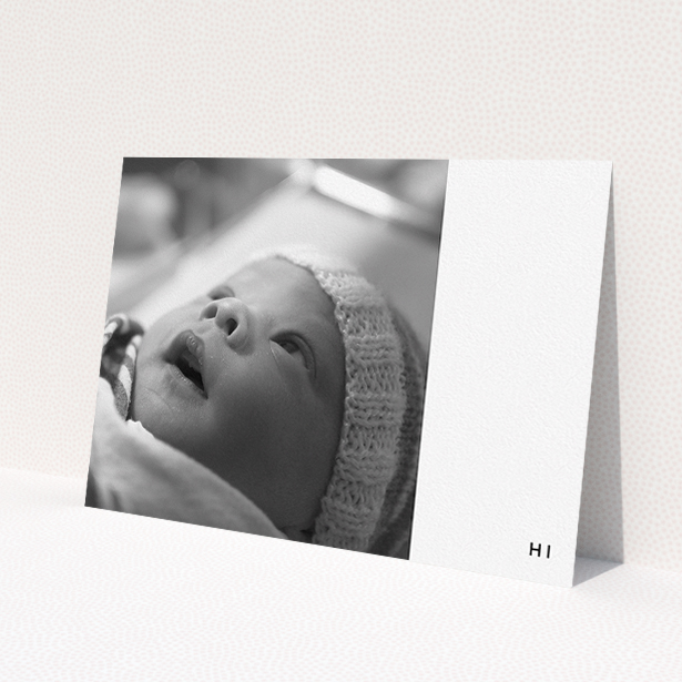 A baptism invitation named "Hi". It is an A5 invite card in a landscape orientation. It is a photographic baptism invitation with room for 1 photo. "Hi" is available as a flat invite card, with mainly white colouring.