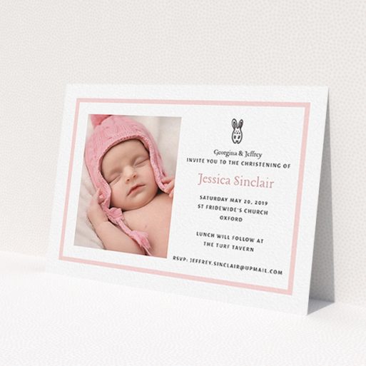 A baptism invitation called 'Little Bunny'. It is an A6 invite card in a landscape orientation. It is a photographic baptism invitation with room for 1 photo. 'Little Bunny' is available as a flat invite card, with tones of pink and white.