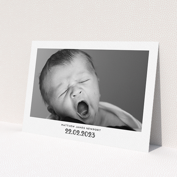 A baptism invitation called 'Ornate Date'. It is an A5 invite card in a landscape orientation. It is a photographic baptism invitation with room for 1 photo. 'Ornate Date' is available as a flat invite card, with mainly white colouring.