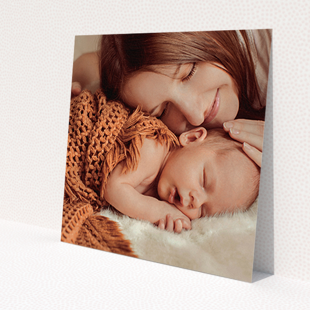 A baptism invitation design called 'Our New Arrival'. It is a square (148mm x 148mm) invite card in a square orientation. It is a photographic baptism invitation with room for 1 photo. 'Our New Arrival' is available as a flat invite card, with mainly white colouring.