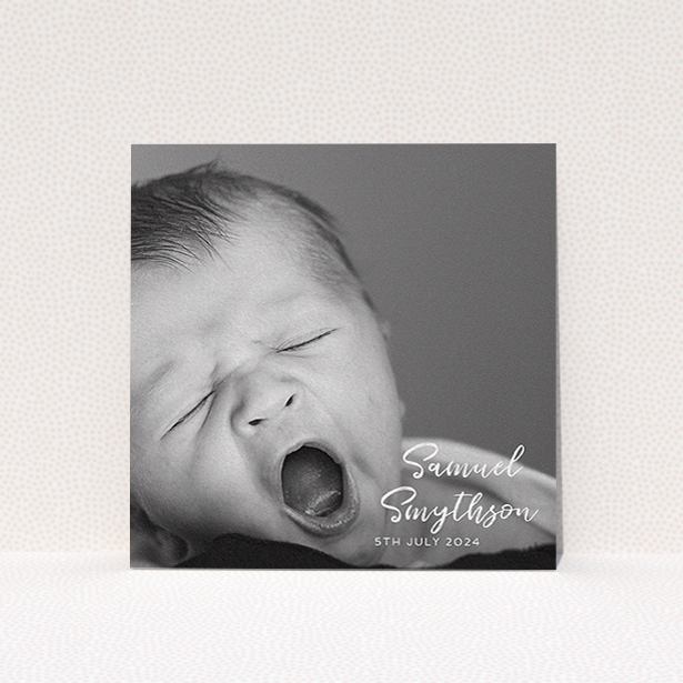 A baptism invitation called "Soho Script". It is a square (148mm x 148mm) invite card in a square orientation. It is a photographic baptism invitation with room for 1 photo. "Soho Script" is available as a flat invite card, with mainly white colouring.