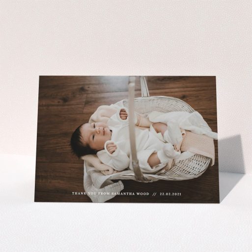 A baptism thank you card template titled "Along the bottom". It is an A5 card in a landscape orientation. It is a photographic baptism thank you card with room for 1 photo. "Along the bottom" is available as a folded card, with mainly white colouring.