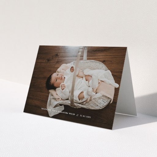 A baptism thank you card template titled 'Along the bottom'. It is an A5 card in a landscape orientation. It is a photographic baptism thank you card with room for 1 photo. 'Along the bottom' is available as a folded card, with mainly white colouring.