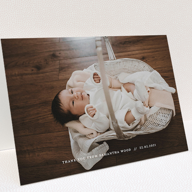 A baptism thank you card template titled "Along the bottom". It is an A5 card in a landscape orientation. It is a photographic baptism thank you card with room for 1 photo. "Along the bottom" is available as a folded card, with mainly white colouring.