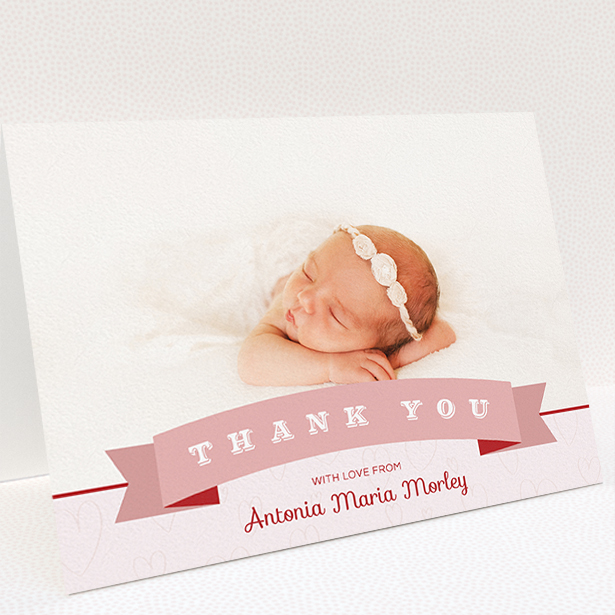 A baptism thank you card called "Big Banner". It is an A5 card in a landscape orientation. It is a photographic baptism thank you card with room for 1 photo. "Big Banner" is available as a folded card, with tones of pink and white.