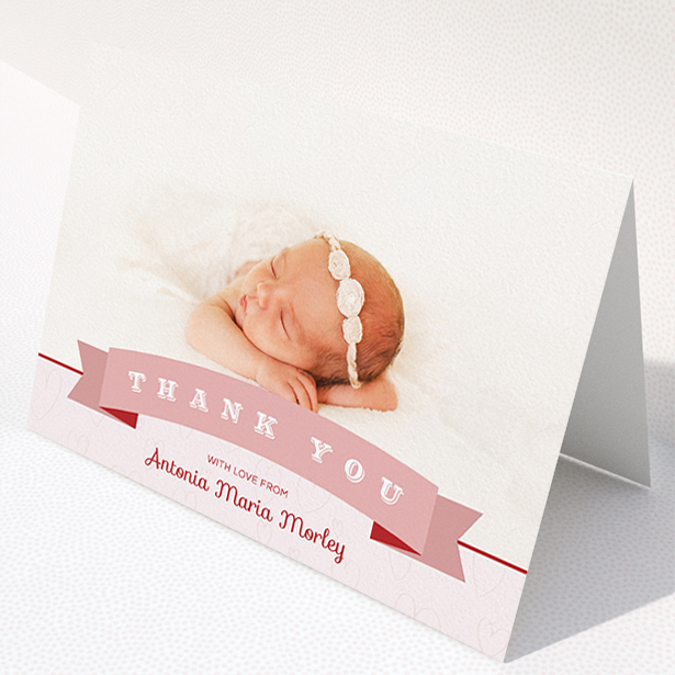 A baptism thank you card called "Big Banner". It is an A5 card in a landscape orientation. It is a photographic baptism thank you card with room for 1 photo. "Big Banner" is available as a folded card, with tones of pink and white.