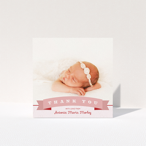 A baptism thank you card template titled "Big Banner". It is a square (148mm x 148mm) card in a square orientation. It is a photographic baptism thank you card with room for 1 photo. "Big Banner" is available as a folded card, with tones of pink and white.