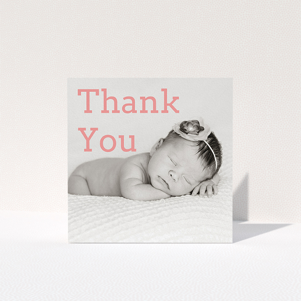 A baptism thank you card design called "Big Thanks". It is a square (148mm x 148mm) card in a square orientation. It is a photographic baptism thank you card with room for 1 photo. "Big Thanks" is available as a folded card, with mainly light pink colouring.