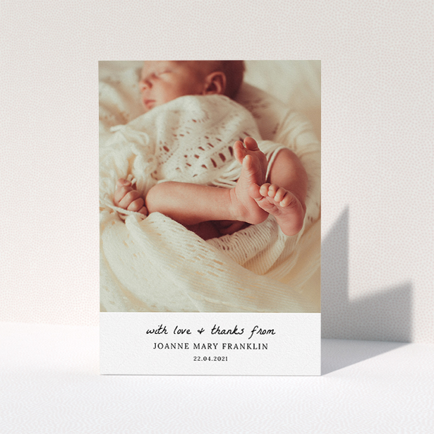 A baptism thank you card design named "Black and White Thanks". It is an A5 card in a portrait orientation. It is a photographic baptism thank you card with room for 1 photo. "Black and White Thanks" is available as a folded card, with mainly white colouring.