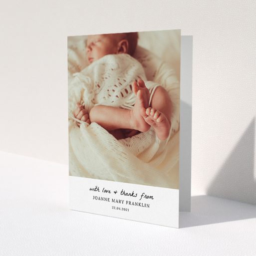 A baptism thank you card design named 'Black and White Thanks'. It is an A5 card in a portrait orientation. It is a photographic baptism thank you card with room for 1 photo. 'Black and White Thanks' is available as a folded card, with mainly white colouring.