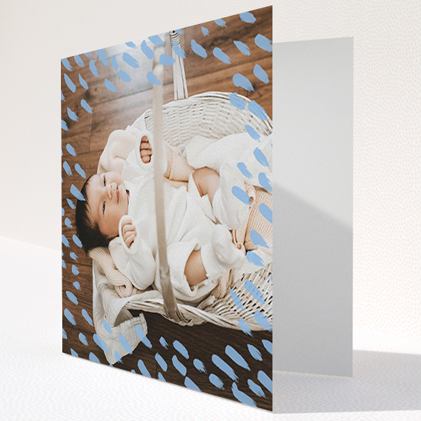 A baptism thank you card design called "Blue Daubs". It is a square (148mm x 148mm) card in a square orientation. It is a photographic baptism thank you card with room for 1 photo. "Blue Daubs" is available as a folded card, with mainly blue colouring.