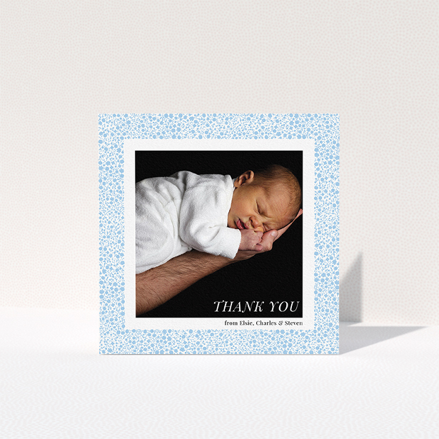 A baptism thank you card template titled "Blue Floral Frame". It is a square (148mm x 148mm) card in a square orientation. It is a photographic baptism thank you card with room for 1 photo. "Blue Floral Frame" is available as a folded card, with tones of blue and white.