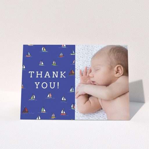 A baptism thank you card template titled "Cowes Week". It is an A5 card in a landscape orientation. It is a photographic baptism thank you card with room for 1 photo. "Cowes Week" is available as a folded card, with tones of blue, green and red.