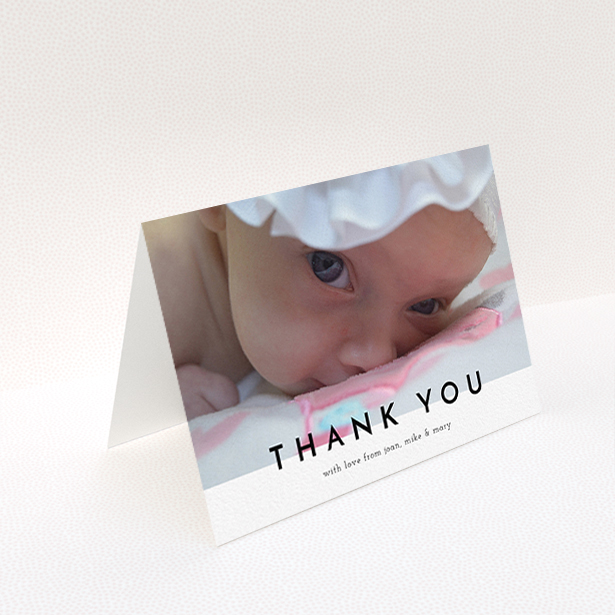 A baptism thank you card design titled "Cross Border". It is an A6 card in a landscape orientation. It is a photographic baptism thank you card with room for 1 photo. "Cross Border" is available as a folded card, with mainly white colouring.