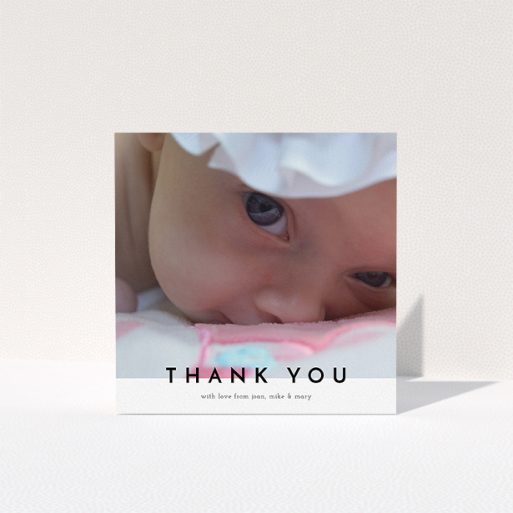 A baptism thank you card design named "Cross Border". It is a square (148mm x 148mm) card in a square orientation. It is a photographic baptism thank you card with room for 1 photo. "Cross Border" is available as a folded card, with mainly white colouring.