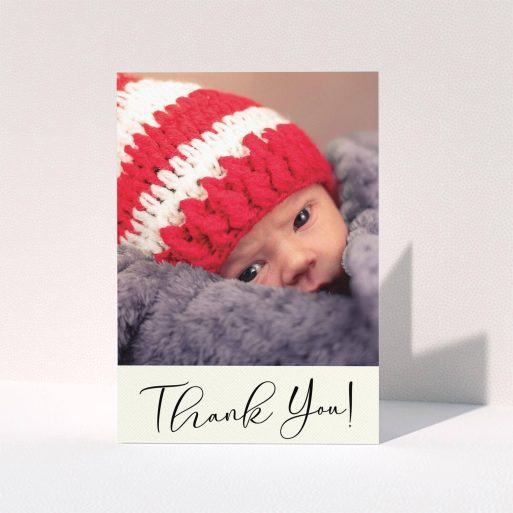 A baptism thank you card design titled "Cursive Thanks". It is an A6 card in a portrait orientation. It is a photographic baptism thank you card with room for 1 photo. "Cursive Thanks" is available as a folded card, with mainly cream colouring.