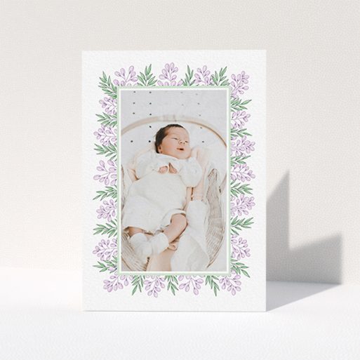 A baptism thank you card design called "Floral Frame". It is an A6 card in a portrait orientation. It is a photographic baptism thank you card with room for 1 photo. "Floral Frame" is available as a folded card, with tones of purple and green.