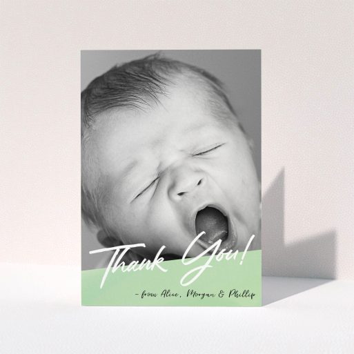 A baptism thank you card design named "Green Slant". It is an A6 card in a portrait orientation. It is a photographic baptism thank you card with room for 1 photo. "Green Slant" is available as a folded card, with tones of green and white.