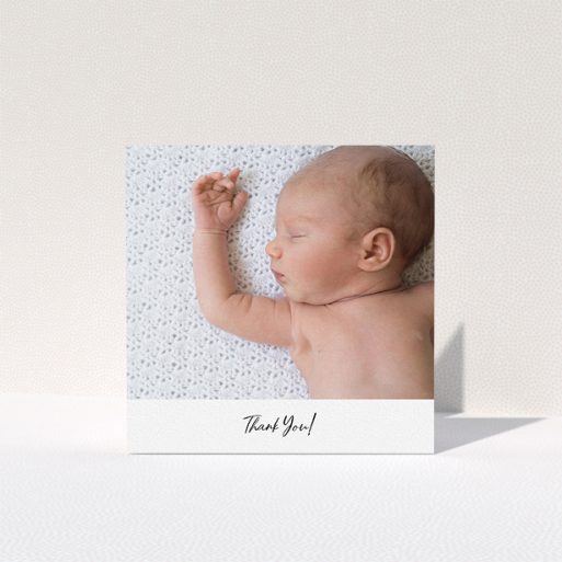 A baptism thank you card template titled "Mr & Mrs Footer". It is a square (148mm x 148mm) card in a square orientation. It is a photographic baptism thank you card with room for 1 photo. "Mr & Mrs Footer" is available as a folded card, with mainly white colouring.