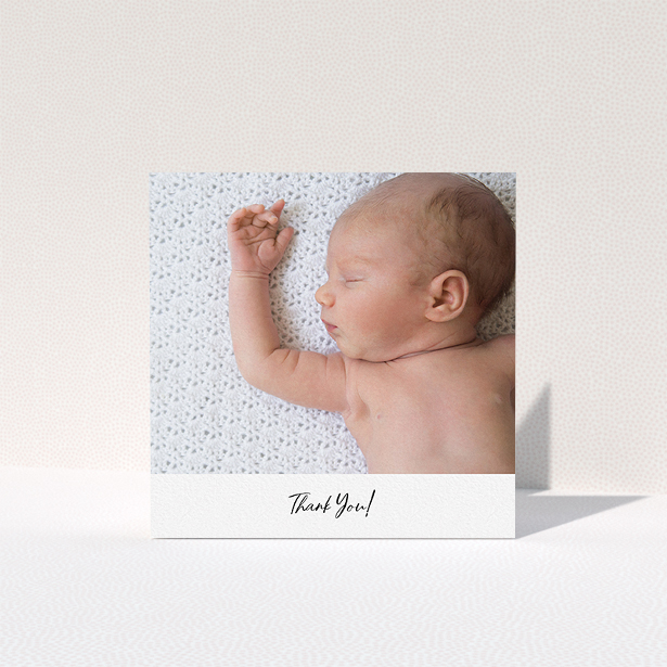 A baptism thank you card template titled "Mr & Mrs Footer". It is a square (148mm x 148mm) card in a square orientation. It is a photographic baptism thank you card with room for 1 photo. "Mr & Mrs Footer" is available as a folded card, with mainly white colouring.