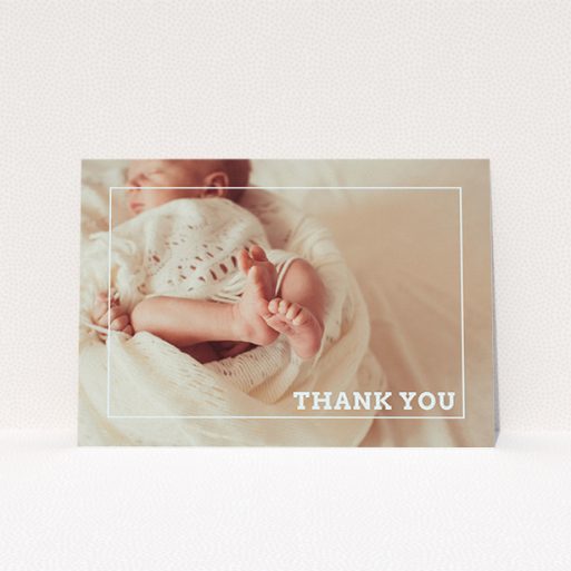A baptism thank you card named "Over Photo Frame". It is an A5 card in a landscape orientation. It is a photographic baptism thank you card with room for 1 photo. "Over Photo Frame" is available as a flat card, with mainly pale pink colouring.