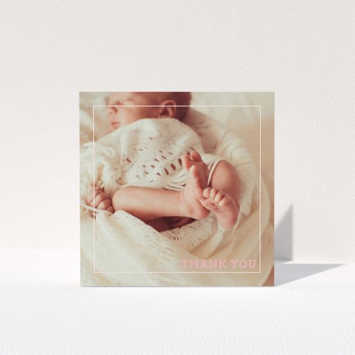 A baptism thank you card called "Over Photo Frame". It is a square (148mm x 148mm) card in a square orientation. It is a photographic baptism thank you card with room for 1 photo. "Over Photo Frame" is available as a folded card, with mainly light pink colouring.