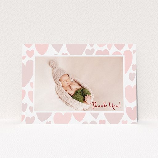 A baptism thank you card design titled "Pastel Hearts". It is an A5 card in a landscape orientation. It is a photographic baptism thank you card with room for 1 photo. "Pastel Hearts" is available as a flat card, with tones of pink and white.