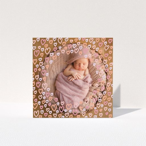 A baptism thank you card called "Pink Hearts". It is a square (148mm x 148mm) card in a square orientation. It is a photographic baptism thank you card with room for 1 photo. "Pink Hearts" is available as a folded card, with mainly pink colouring.