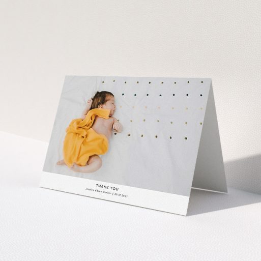 A baptism thank you card design named 'Sans Serif'. It is an A5 card in a landscape orientation. It is a photographic baptism thank you card with room for 1 photo. 'Sans Serif' is available as a folded card, with mainly white colouring.