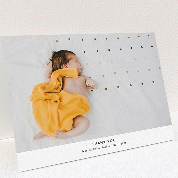 A baptism thank you card design named "Sans Serif". It is an A5 card in a landscape orientation. It is a photographic baptism thank you card with room for 1 photo. "Sans Serif" is available as a folded card, with mainly white colouring.