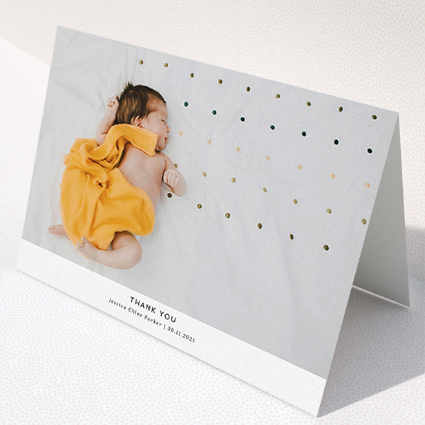 A baptism thank you card design named "Sans Serif". It is an A5 card in a landscape orientation. It is a photographic baptism thank you card with room for 1 photo. "Sans Serif" is available as a folded card, with mainly white colouring.