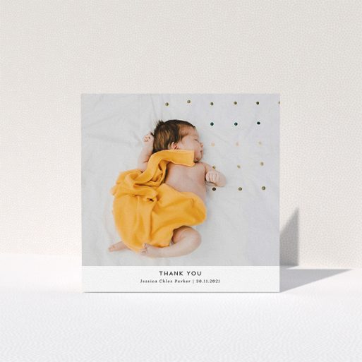 A baptism thank you card design titled "Sans Serif". It is a square (148mm x 148mm) card in a square orientation. It is a photographic baptism thank you card with room for 1 photo. "Sans Serif" is available as a folded card, with mainly white colouring.