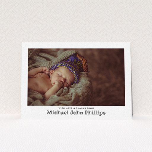 A baptism thank you card named "Simple Photo Frame". It is an A6 card in a landscape orientation. It is a photographic baptism thank you card with room for 1 photo. "Simple Photo Frame" is available as a flat card, with mainly white colouring.