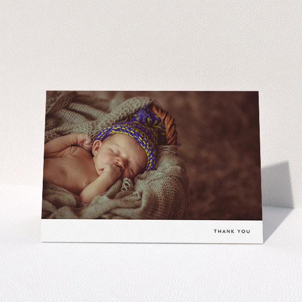 A baptism thank you card design titled "Thankful with Simplicity". It is an A5 card in a landscape orientation. It is a photographic baptism thank you card with room for 1 photo. "Thankful with Simplicity" is available as a folded card, with mainly white colouring.