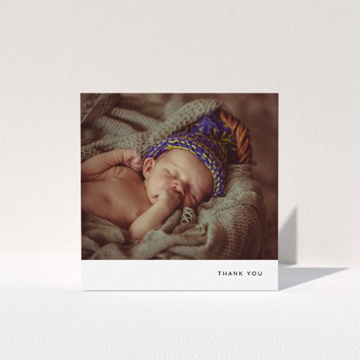 A baptism thank you card called "Thankful with Simplicity". It is a square (148mm x 148mm) card in a square orientation. It is a photographic baptism thank you card with room for 1 photo. "Thankful with Simplicity" is available as a folded card, with mainly white colouring.