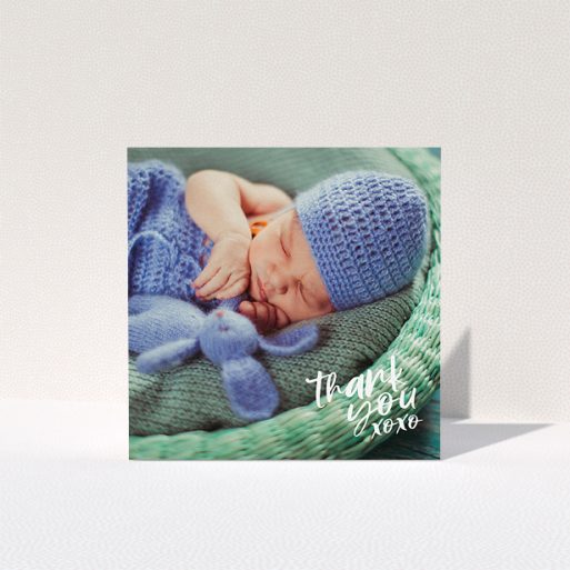 A baptism thank you card named "Thanks In the Corner". It is a square (148mm x 148mm) card in a square orientation. It is a photographic baptism thank you card with room for 1 photo. "Thanks In the Corner" is available as a folded card, with mainly white colouring.