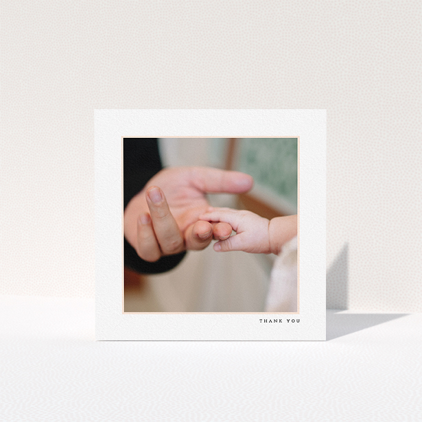 A baptism thank you card named "Thin Pink Frame". It is a square (148mm x 148mm) card in a square orientation. It is a photographic baptism thank you card with room for 1 photo. "Thin Pink Frame" is available as a folded card, with tones of white and pink.