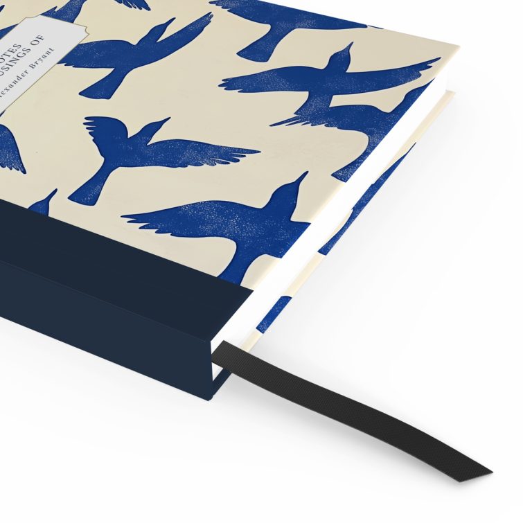 Blue bird-themed notebook cover design with two photos on the back, featuring abstract bird illustrations spreading across the front, spine, and back cover.